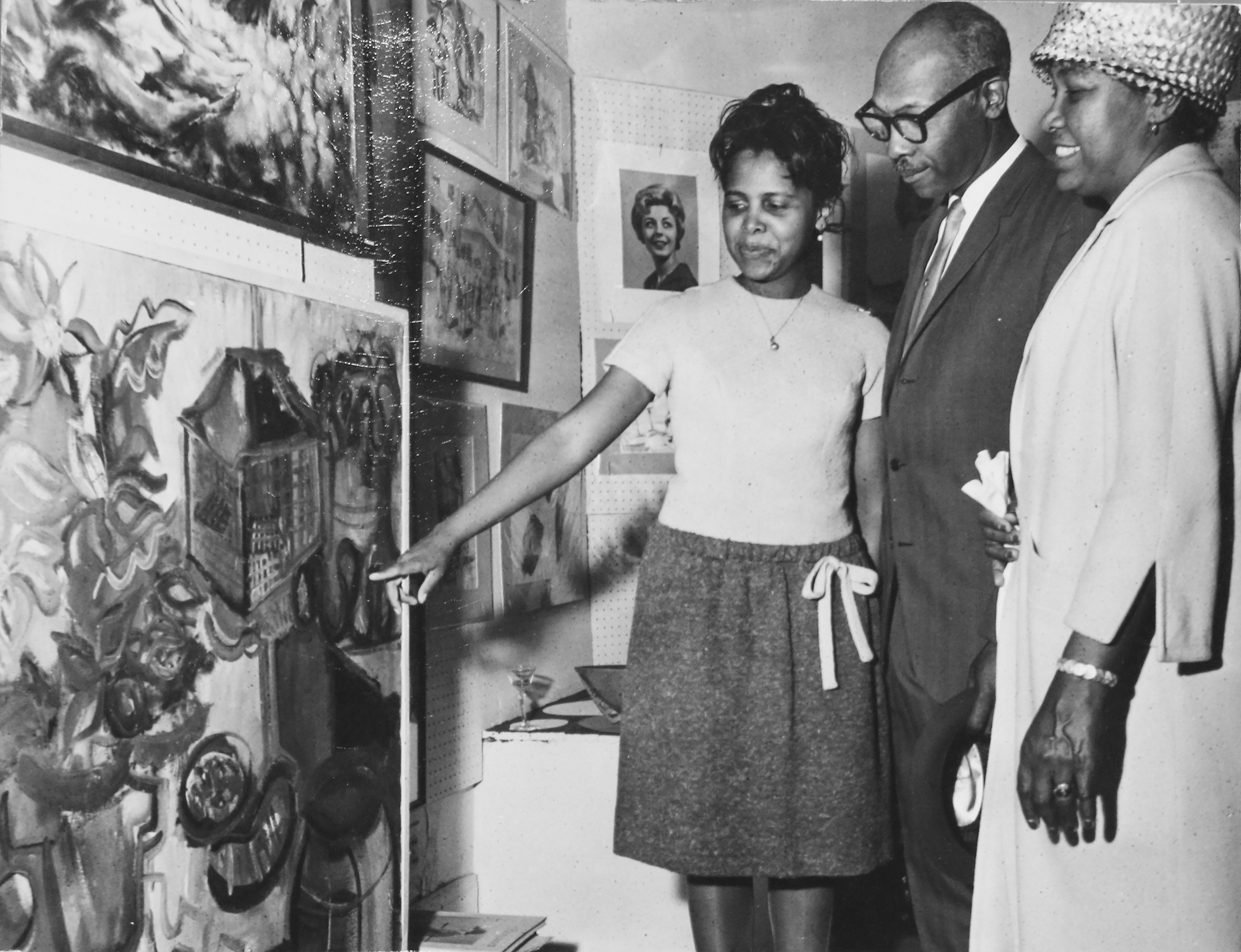 Shirley Woodson sharing her work with parents, Claude and Celia Woodson, at Detroit's Arts Extended Gallery in the early 1960s. Photo by James D. Wilson, courtesy Shirley Woodson.